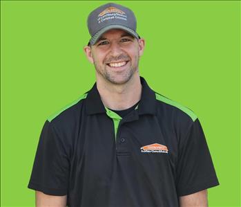 SERVPRO employee in front of green background