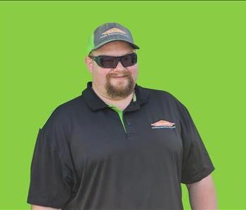 SERVPRO employee in front of green background