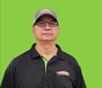 SERVPRO employee in front of green background