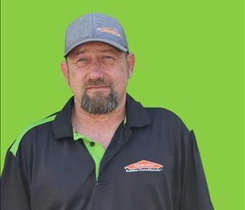 SERVPRO employee in front of green background