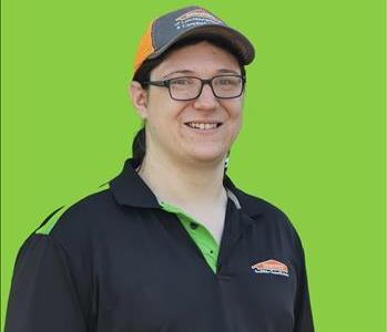 SERVPRO employee in front of green background