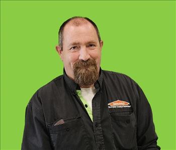 SERVPRO employee in front of green background