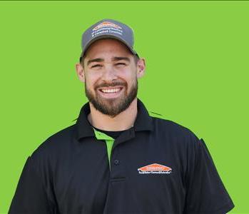 SERVPRO employee in front of green background