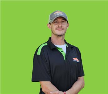 SERVPRO employee in front of green background