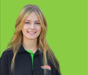 SERVPRO employee in front of green background