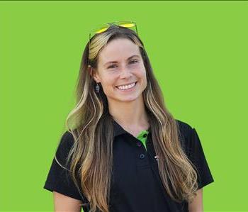 SERVPRO employee in front of green background