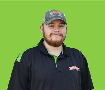 SERVPRO employee in front of green background