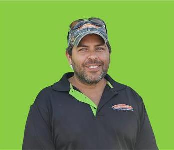 SERVPRO employee in front of green background