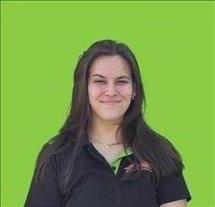 SERVPRO employee in front of green background