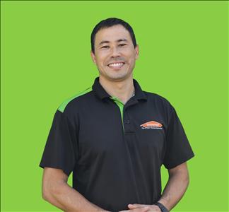 SERVPRO employee in front of green background