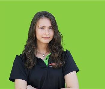 SERVPRO employee in front of green background