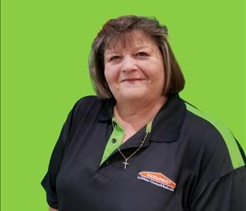 SERVPRO employee in front of green background