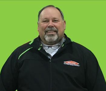 SERVPRO employee in front of green background