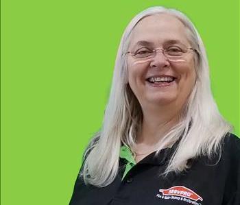 SERVPRO employee in front of green background