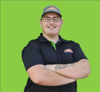 SERVPRO employee in front of green background