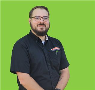 SERVPRO employee in front of green background